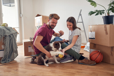 Millennial first-time homebuyers move into their new home with dog
