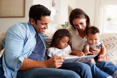 Family reading a book.